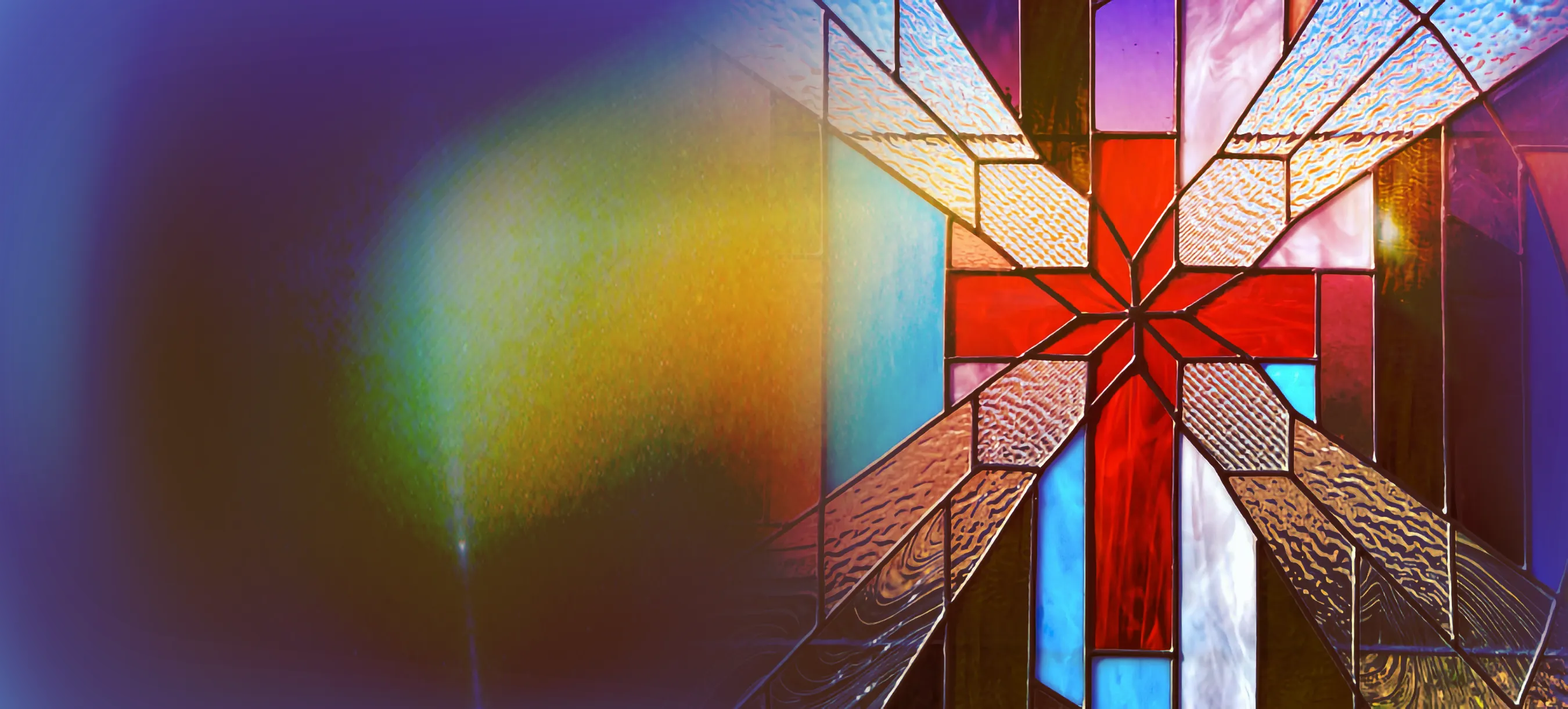 A stained-glass window in the Gift of Grace sanctuary